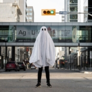 worker in middle of street wearing ghost costume